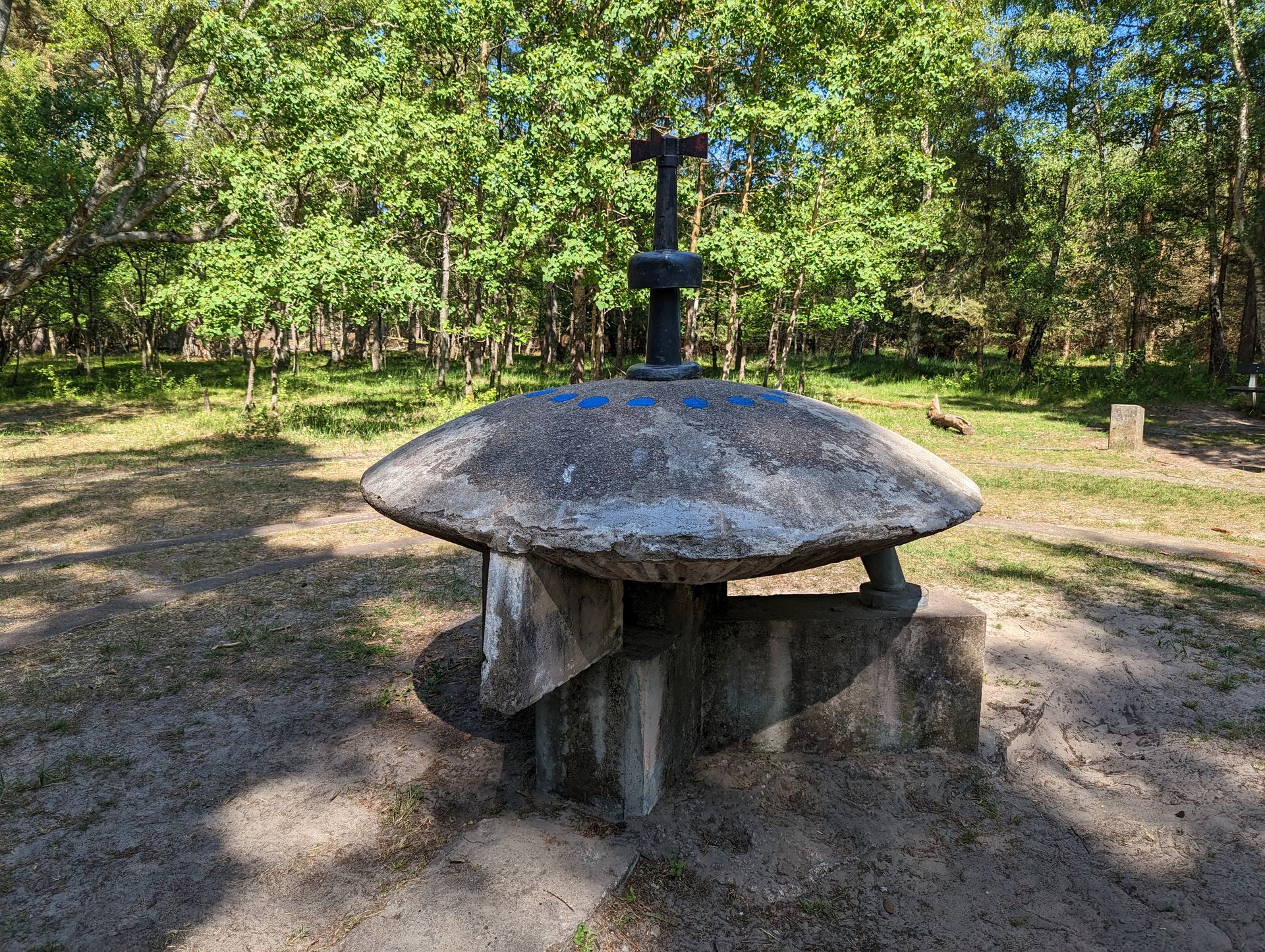 The Ängelholm UFO memorial, a 1:8-scale concrete flying saucer model on a pedestal in Kronoskogen forest, Sweden