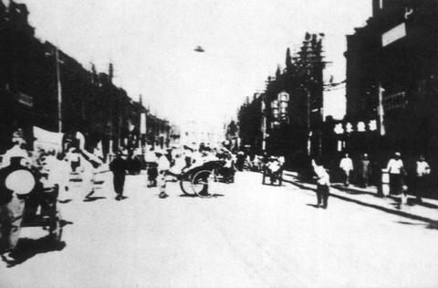 The Hopeh Incident photograph: a crowd of pedestrians on a Tientsin street, several pointing upward at a dark, conical object hovering above the rooftops