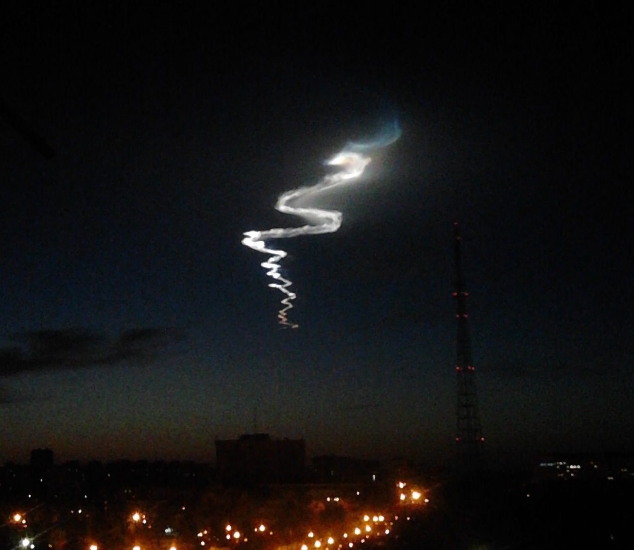 A Topol-M intercontinental ballistic missile launch from the Kapustin Yar test range, its stage-separation exhaust glowing and refracting light in the upper atmosphere — the actual missile range where the 1989 sighting occurred, not a photograph of the reported object itself