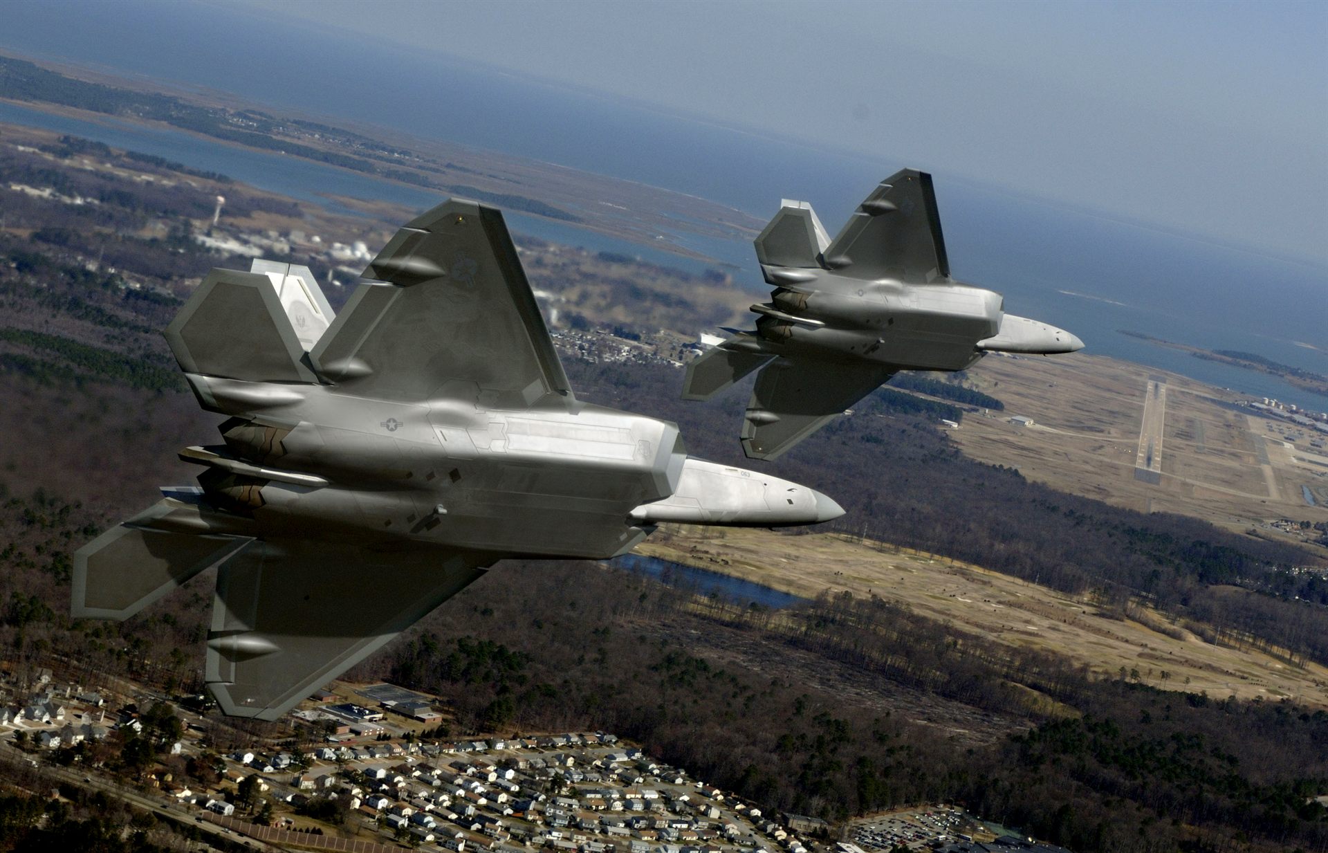 U.S. Air Force F-22A Raptors of the 1st Fighter Wing on final approach to Langley Air Force Base, Virginia — the installation later breached by the December 2023 UAP swarm