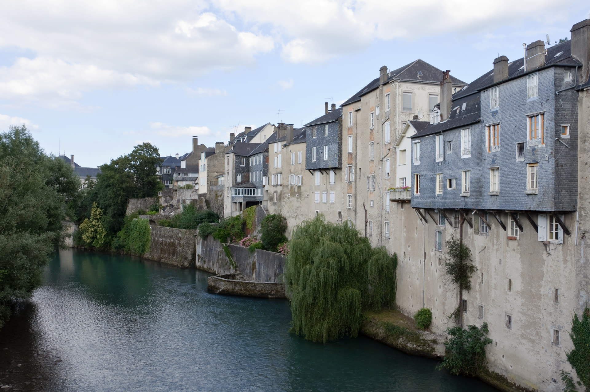 Riverside houses along the Gave d'Aspe in Oloron-Sainte-Marie, Pyrénées-Atlantiques, France